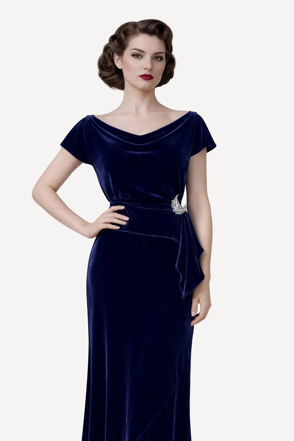 Woman wearing a navy velvet maxi dress with a white background