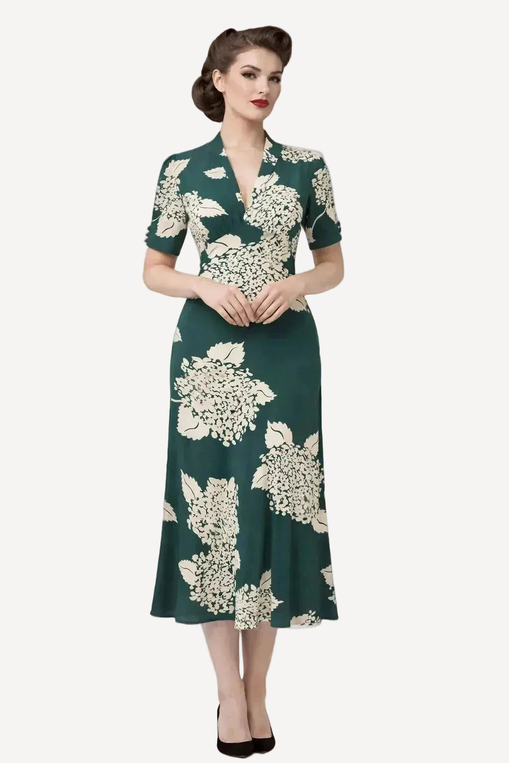 Woman wearing a green floral dress on a white background