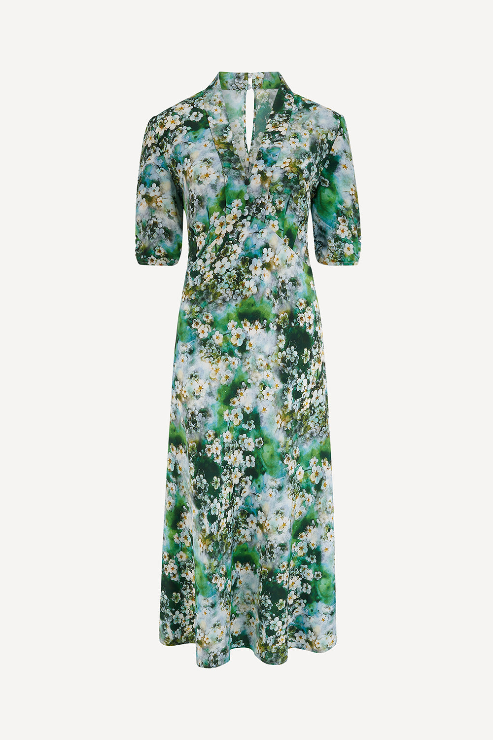 Floral dress in a 1940s style with green and white pattern on a white background