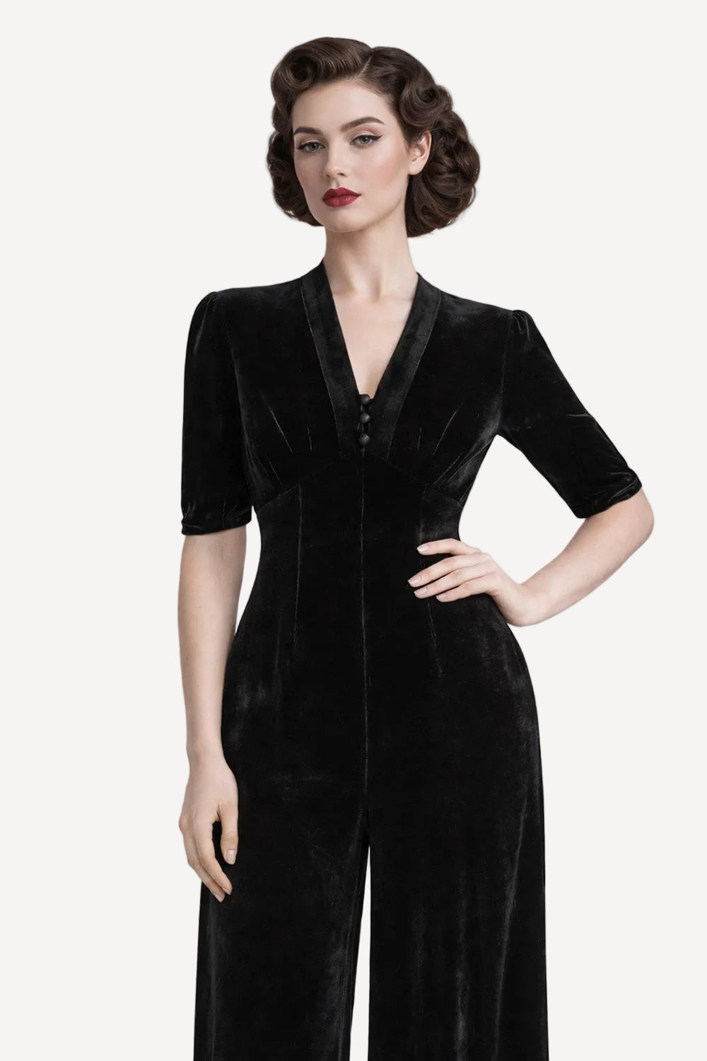 black velvet jumpsuit worn by model against a white background