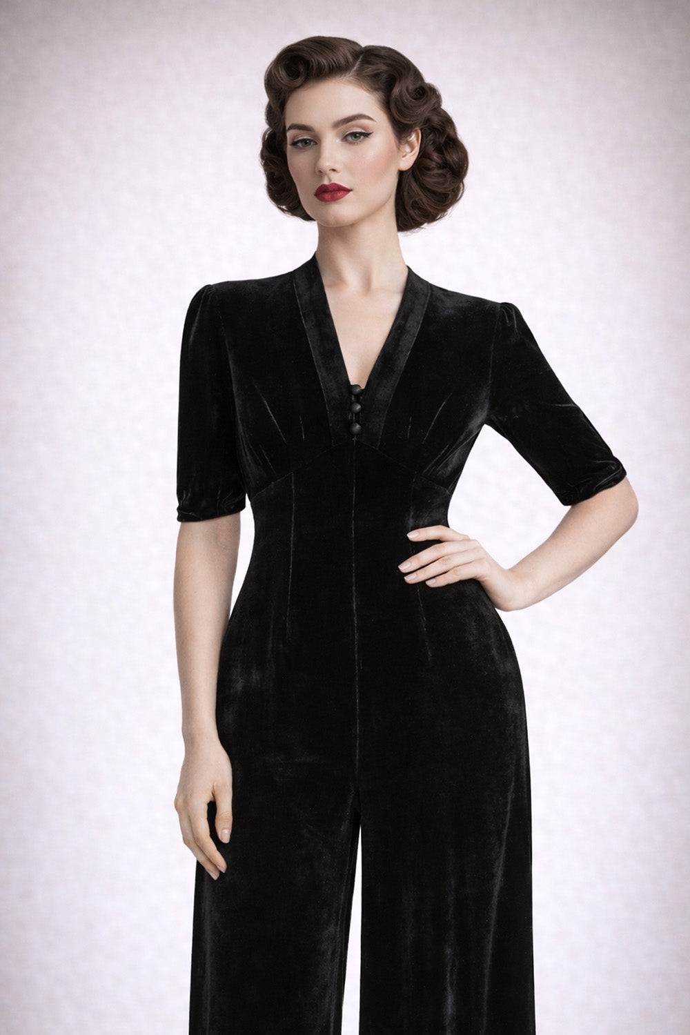 black velvet jumpsuit worn by model against a white background