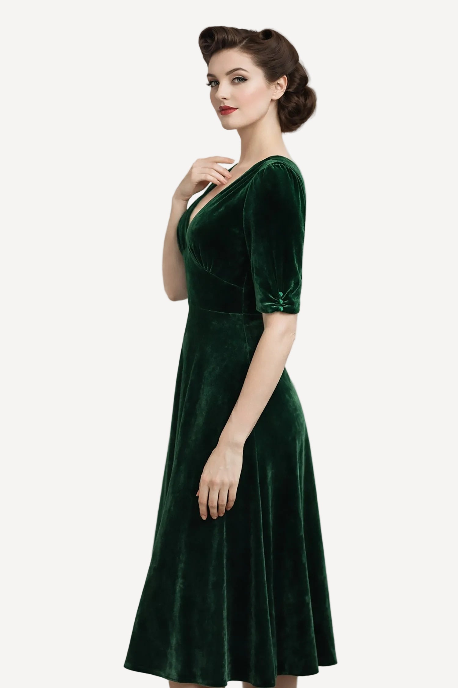 Woman wearing a green velvet dress against a plain background