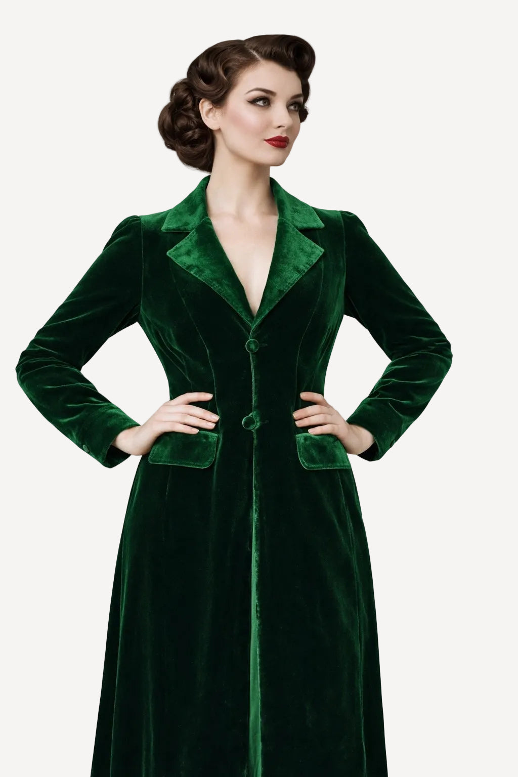 Woman wearing a green velvet coat against a plain background