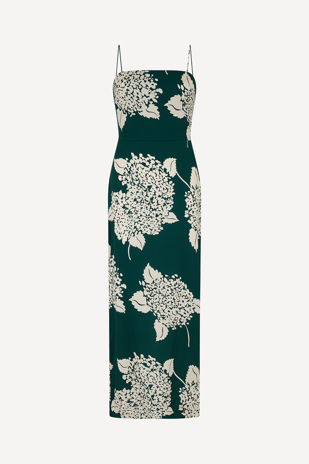 A silk dark green sleeveless maxi dress with a white floral print and thin spaghetti straps, shown against a plain light grey background.