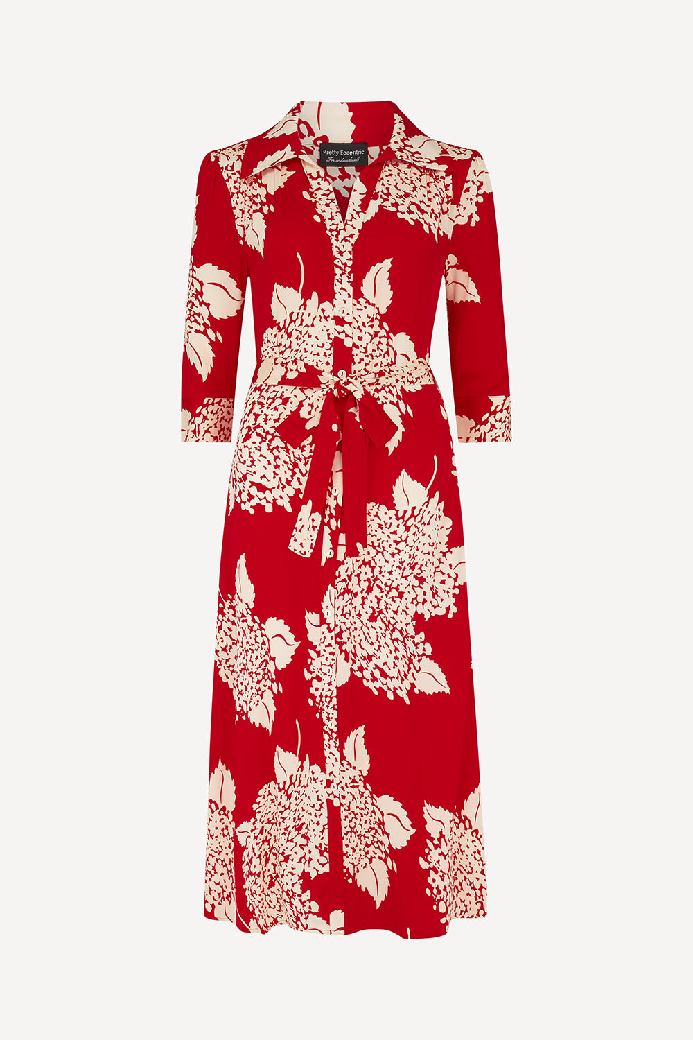 A red three-quarter sleeve midi shirt dress with a cream floral print, featuring a pointed collar, button-up front, and a matching fabric tie belt at the waist, shown against a light grey background.