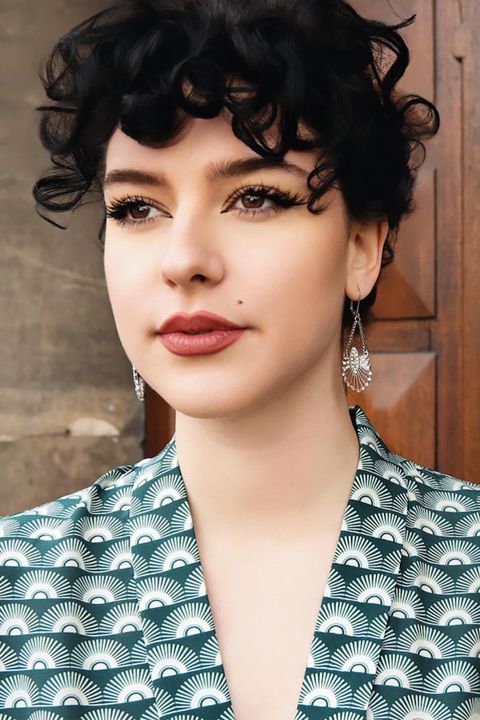 Model wearing green fan print jumpsuit