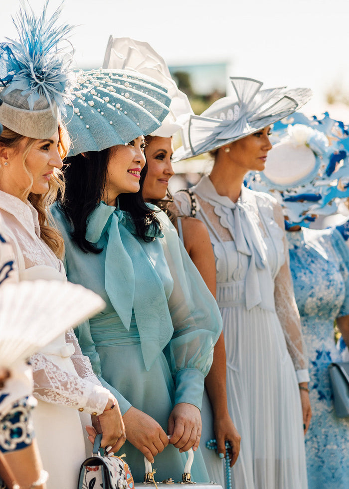 Two female models wearing race day outfits