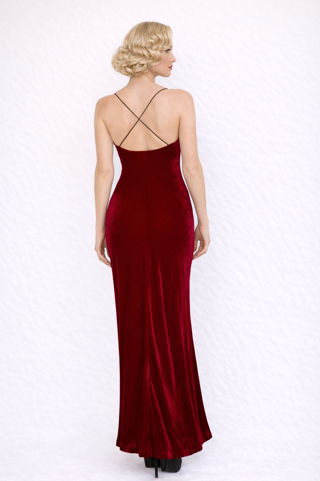 Woman wearing a red black tie evening gown with a white background
