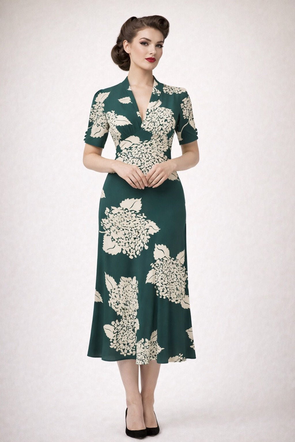 Woman wearing a green floral dress on a white background