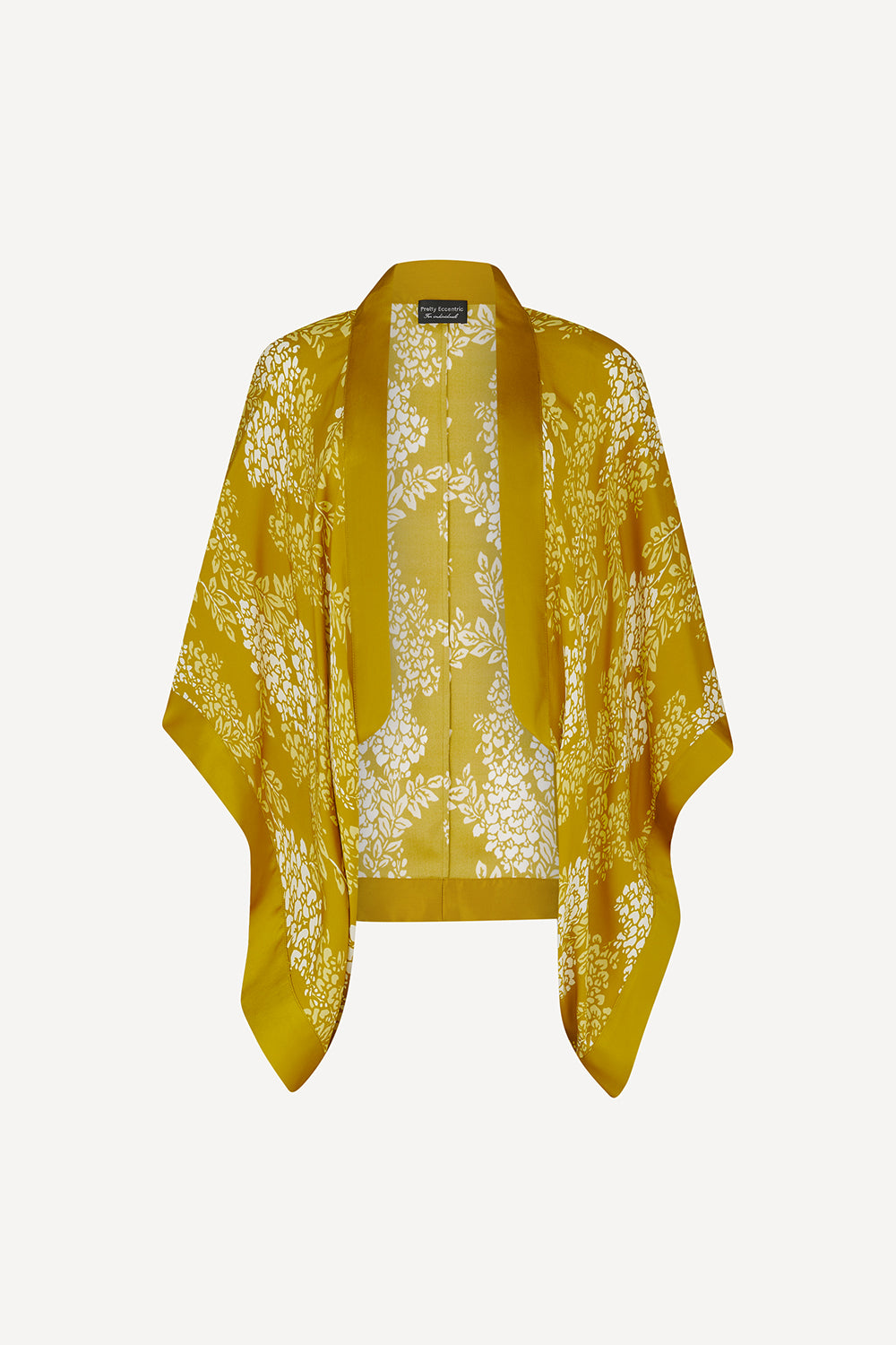 A mustard yellow open-front kimono-style cardigan with wide sleeves, featuring a white floral pattern and a beige lace insert lining, displayed flat against a light gray background.