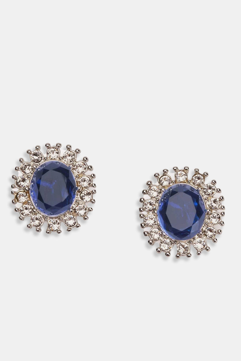 A pair of earrings featuring a central sapphire stone surrounded by smaller crystal stones, set against a white background.
