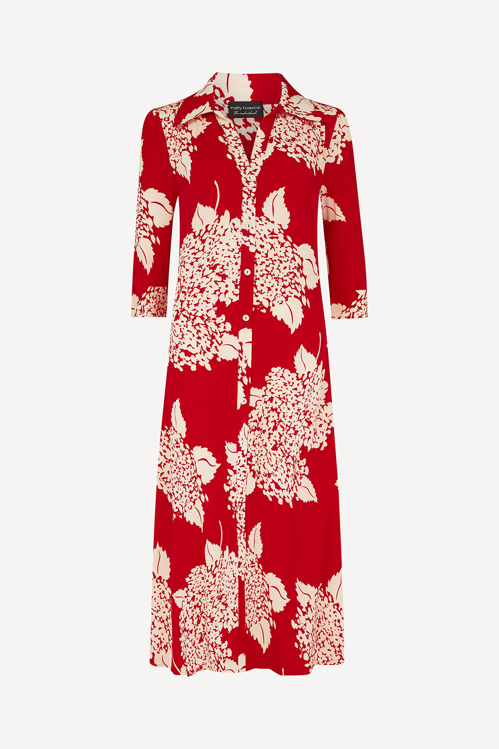 A red long-sleeve button-front dress with a large cream floral print, shown against a light gray background.